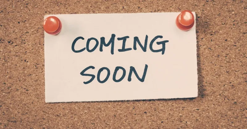 Coming soon note pinned to a corkboard
